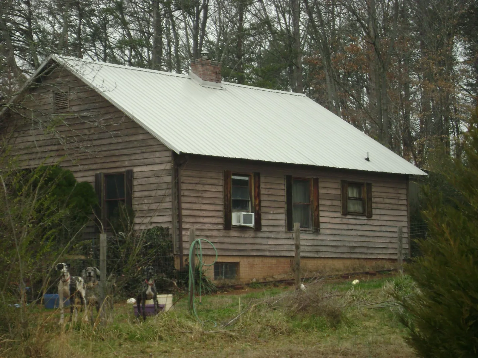 White metal roof on an old wood sided farmhouse, from a Metal Roof Installation job in Callender